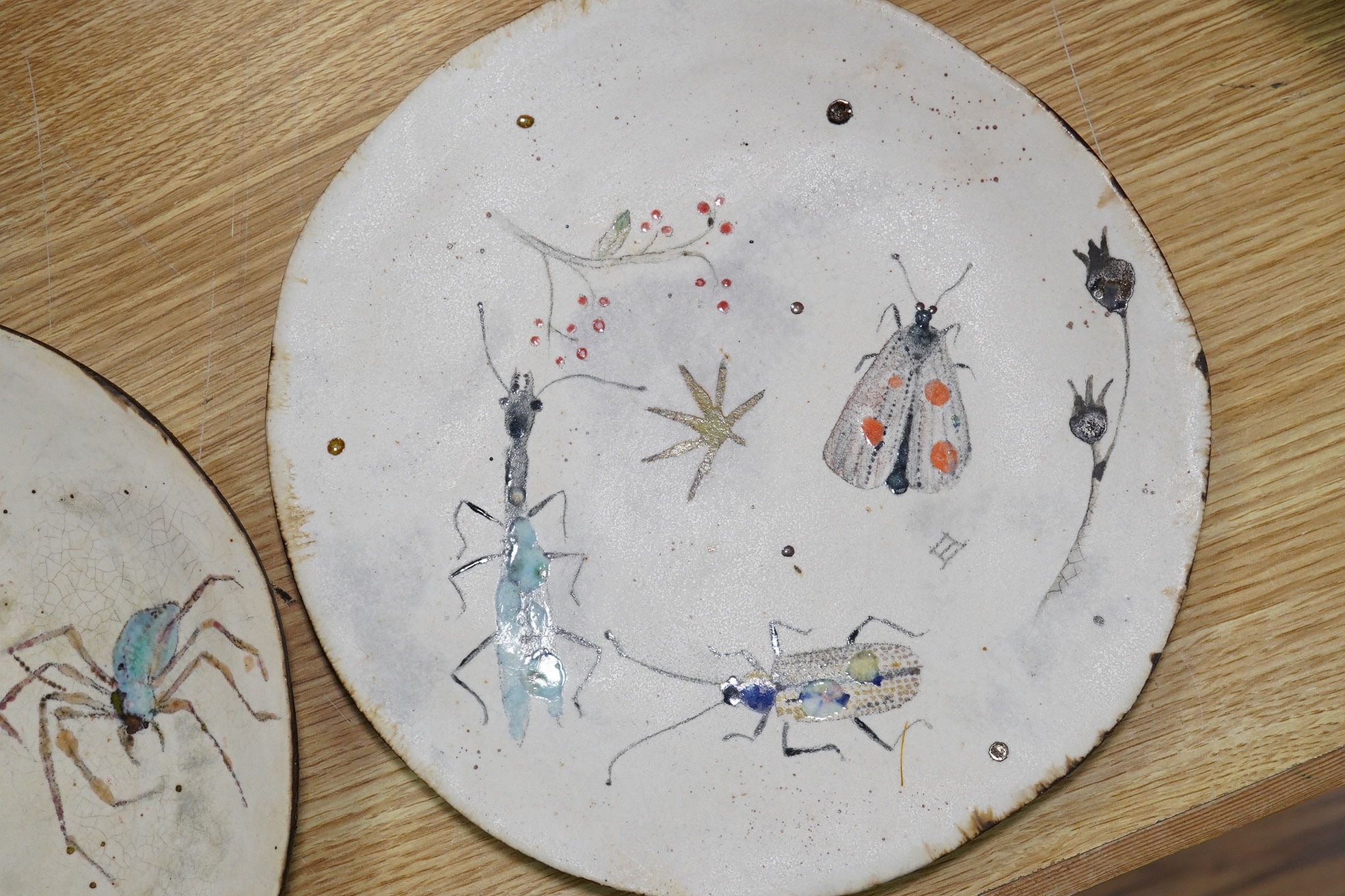 A pair of Eva Hernandez pottery plates, 26cm. Condition - good